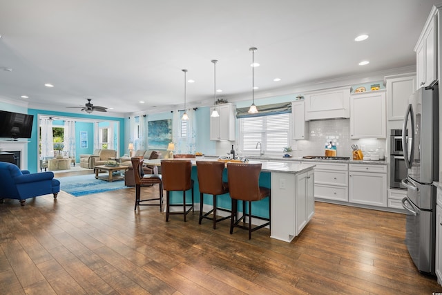 1290 Prescott Cir, Myrtle Beach, SC 29577 - kitchen with open floor plan, stainless steel appliances, a kitchen island, ornamental molding, and a breakfast bar