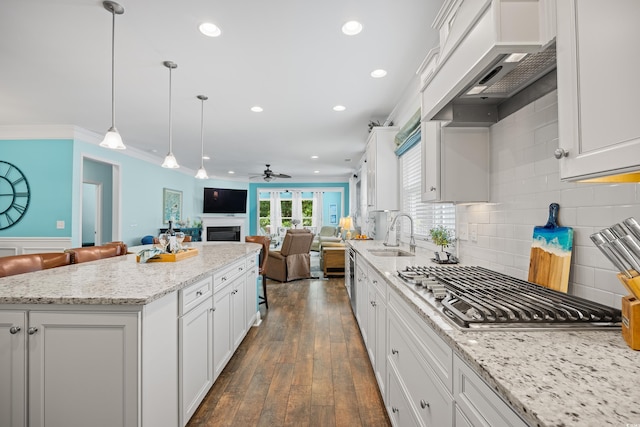 1290 Prescott Cir, Myrtle Beach, SC 29577 - kitchen featuring a sink, open floor plan, a ceiling fan, white cabinetry, and stainless steel gas stovetop