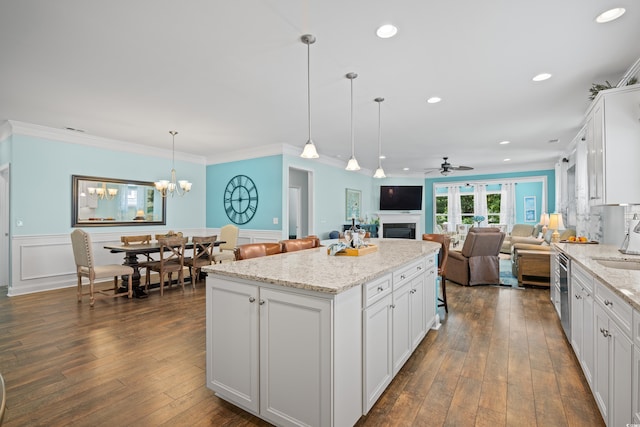 1290 Prescott Cir, Myrtle Beach, SC 29577 - kitchen with open floor plan, a ceiling fan, a wainscoted wall, white cabinetry, and a kitchen island