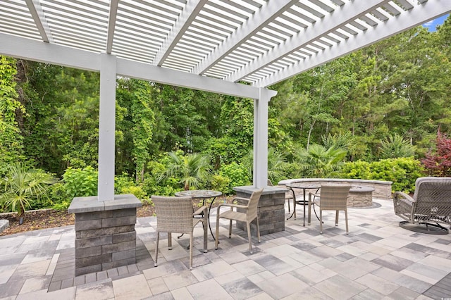 1290 Prescott Cir, Myrtle Beach, SC 29577 - view of patio / terrace featuring outdoor dining space, a pergola, and view of wooded area