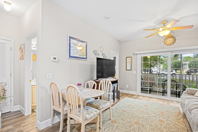 dining area featuring a ceiling fan, light wood finished floors, and baseboards