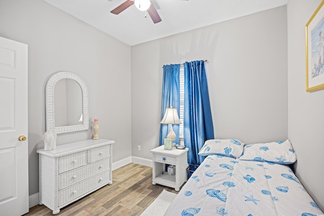 bedroom with wood finished floors, baseboards, and ceiling fan