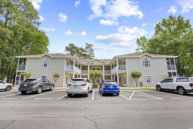view of property with uncovered parking