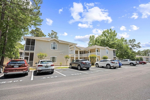 view of property featuring uncovered parking
