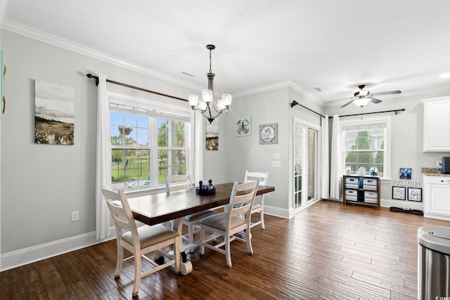 dining room featuring a chandelier, ornamental molding, dark wood-type flooring, baseboards, and a ceiling fan