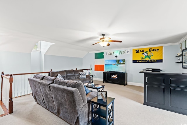 carpeted living room with ceiling fan, baseboards, and lofted ceiling