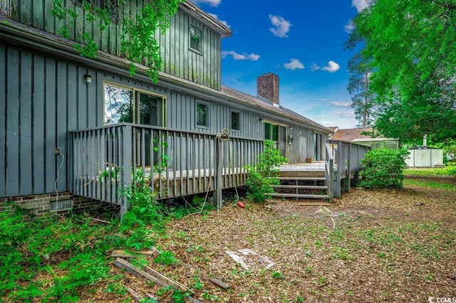 2010 Ye Olde Kings Hwy, North Myrtle Beach, SC 29582 - rear view of property with a wooden deck, a chimney, board and batten siding, and a shed