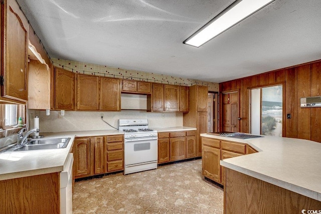 2010 Ye Olde Kings Hwy, North Myrtle Beach, SC 29582 - kitchen with white appliances, a sink, light countertops, brown cabinets, and wood walls