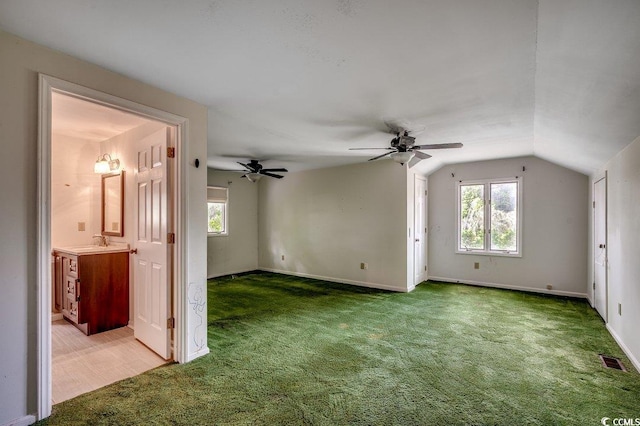 2010 Ye Olde Kings Hwy, North Myrtle Beach, SC 29582 - carpeted empty room with vaulted ceiling, a sink, plenty of natural light, and baseboards