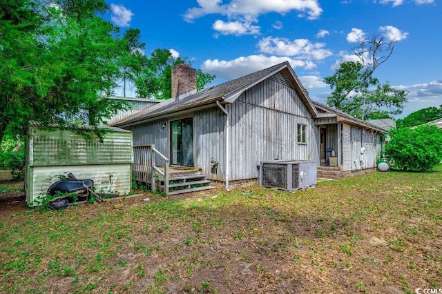 2010 Ye Olde Kings Hwy, North Myrtle Beach, SC 29582 - rear view of property featuring central AC and a chimney
