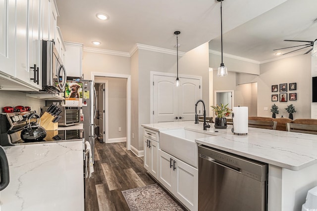 kitchen with stainless steel appliances, a sink, ornamental molding, white cabinetry, and a ceiling fan