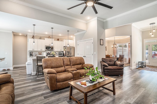 living room featuring a ceiling fan, baseboards, dark wood finished floors, ornamental molding, and recessed lighting