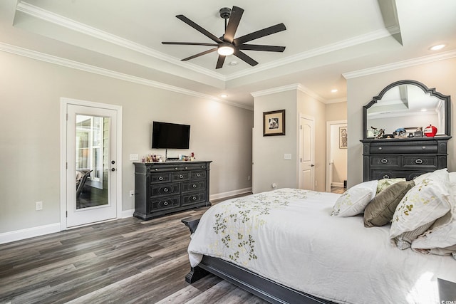 bedroom featuring a raised ceiling, wood finished floors, ornamental molding, baseboards, and recessed lighting