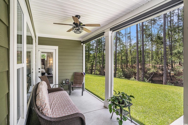 sunroom featuring a ceiling fan