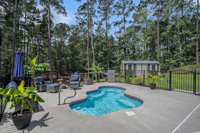 view of swimming pool featuring a patio, fence, an outdoor structure, and area for grilling