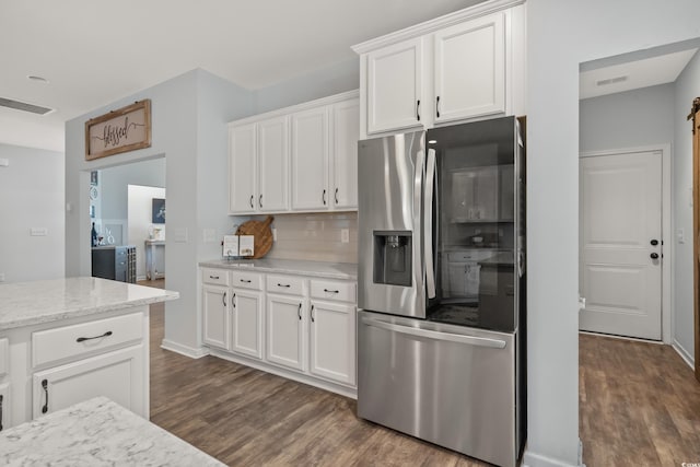 3620 Diamond Stars Way, Little River, SC 29566 - kitchen with stainless steel fridge, dark wood-style floors, white cabinetry, decorative backsplash, and light stone counters