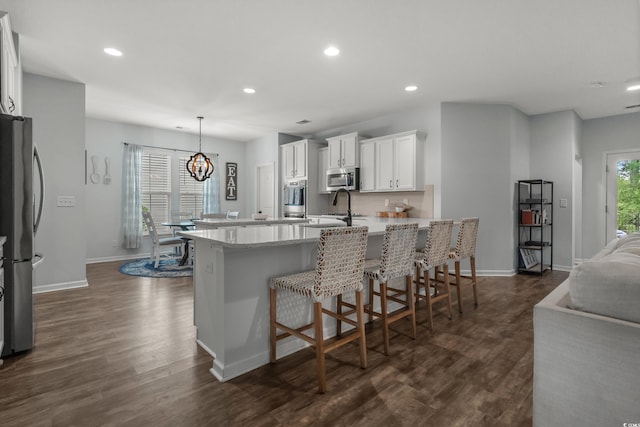 3620 Diamond Stars Way, Little River, SC 29566 - kitchen with stainless steel appliances, a peninsula, baseboards, recessed lighting, and dark wood-style flooring