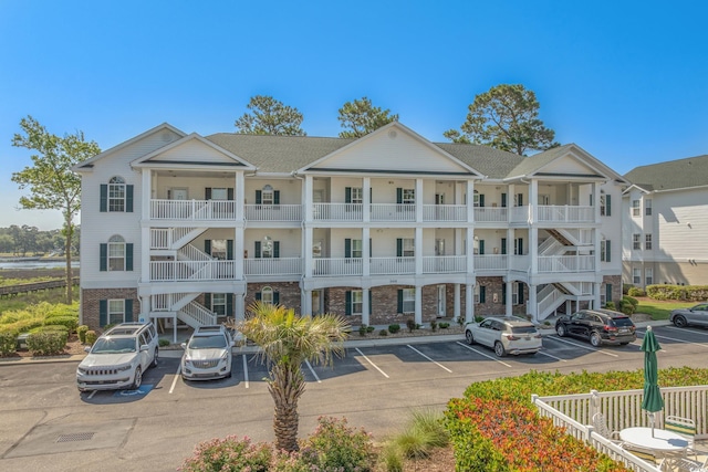 4450 Turtle Ln Unit 2-A, Little River, SC 29566 - view of building exterior with uncovered parking and stairs