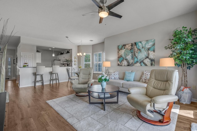 4450 Turtle Ln Unit 2-A, Little River, SC 29566 - living area with a ceiling fan, wood finished floors, a chandelier, and baseboards