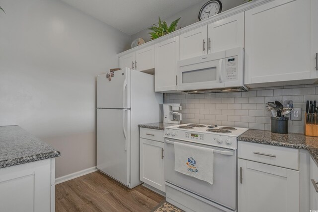 4450 Turtle Ln Unit 2-A, Little River, SC 29566 - kitchen featuring white appliances, white cabinetry, wood finished floors, backsplash, and baseboards