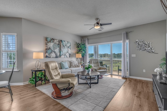 4450 Turtle Ln Unit 2-A, Little River, SC 29566 - living room with a ceiling fan, plenty of natural light, wood finished floors, baseboards, and a textured ceiling