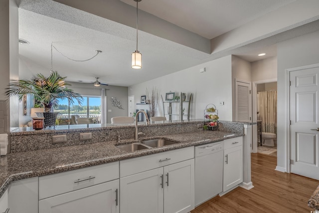 4450 Turtle Ln Unit 2-A, Little River, SC 29566 - kitchen with dishwasher, a sink, decorative light fixtures, light wood-type flooring, and white cabinets