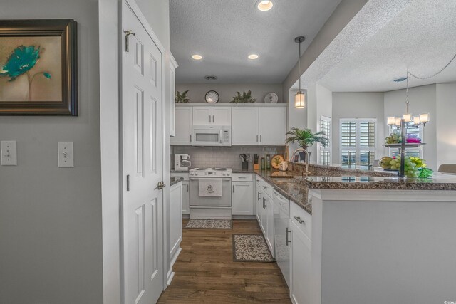 4450 Turtle Ln Unit 2-A, Little River, SC 29566 - kitchen featuring white appliances, a sink, a textured ceiling, white cabinets, and dark wood finished floors