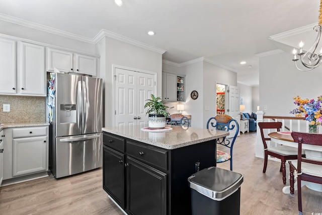 815 Murray Ave, Myrtle Beach, SC 29577 - kitchen featuring stainless steel refrigerator with ice dispenser, dark cabinetry, a center island, light wood finished floors, and white cabinets