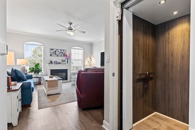 815 Murray Ave, Myrtle Beach, SC 29577 - living area with ceiling fan, crown molding, wood finished floors, a glass covered fireplace, and recessed lighting