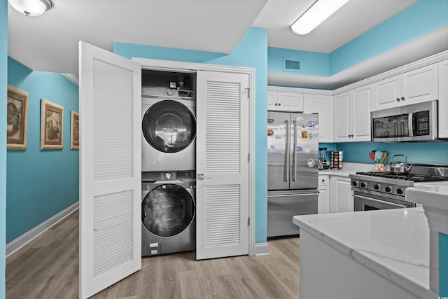 100 N Beach Blvd Unit 515, North Myrtle Beach, SC 29582 - laundry room featuring stacked washing machine and dryer and light wood finished floors