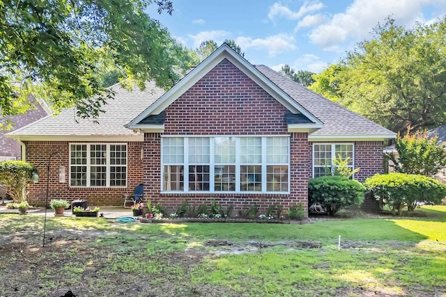 3071 Alice Ln, Little River, SC 29566 - rear view of property with brick siding, a yard, a shingled roof, and a patio