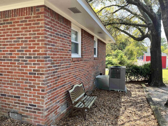505 1st Ave S, North Myrtle Beach, SC 29582 - view of side of property featuring crawl space, central AC, and brick siding