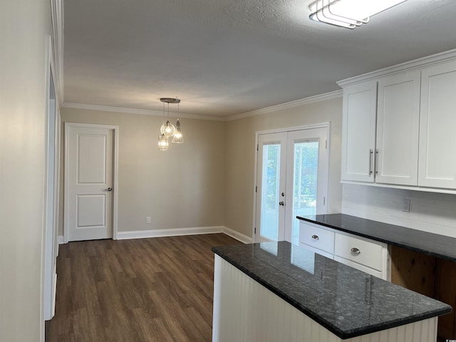 505 1st Ave S, North Myrtle Beach, SC 29582 - kitchen with dark wood finished floors, baseboards, white cabinets, crown molding, and tasteful backsplash