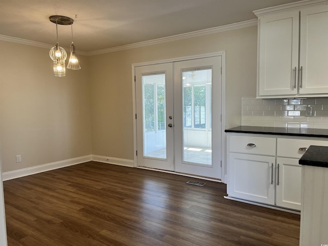 505 1st Ave S, North Myrtle Beach, SC 29582 - unfurnished dining area with crown molding, dark wood-style floors, french doors, and baseboards