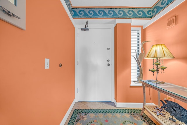 entrance foyer featuring baseboards, plenty of natural light, and tile patterned floors