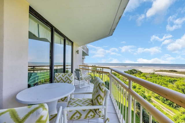balcony with view of water and beach