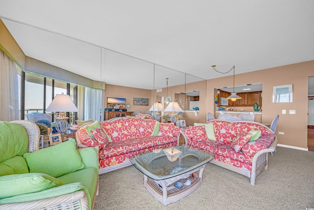 carpeted living room with plenty of natural light and baseboards