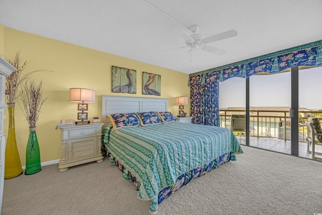 carpeted bedroom featuring access to exterior, a ceiling fan, and baseboards