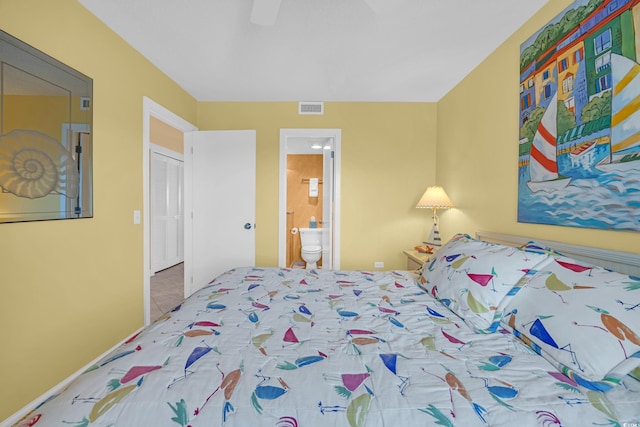 tiled bedroom with ensuite bath and ceiling fan
