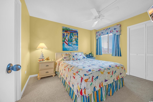 carpeted bedroom with ceiling fan and baseboards