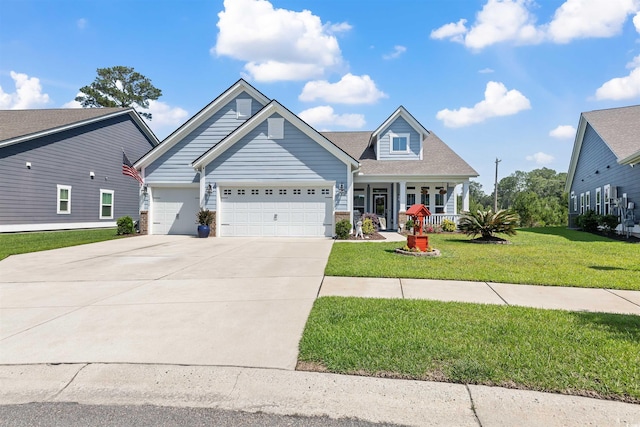 view of front of house with a garage, concrete driveway, a front lawn, and a porch
