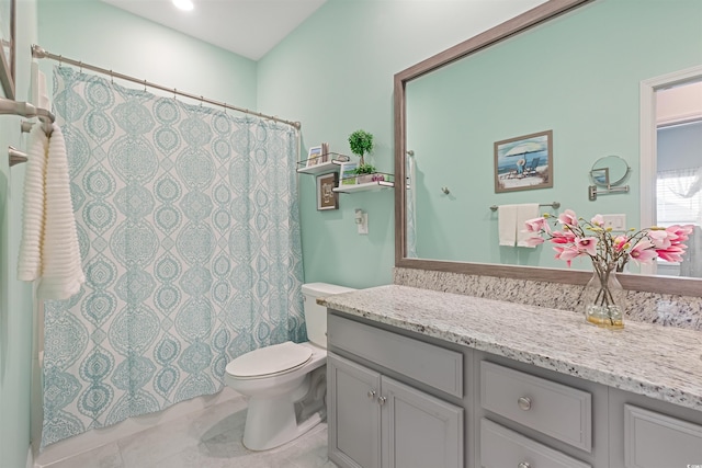 bathroom featuring toilet, vanity, curtained shower, and tile patterned floors