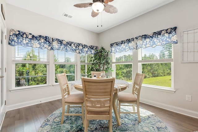 dining room with a ceiling fan, baseboards, and wood finished floors