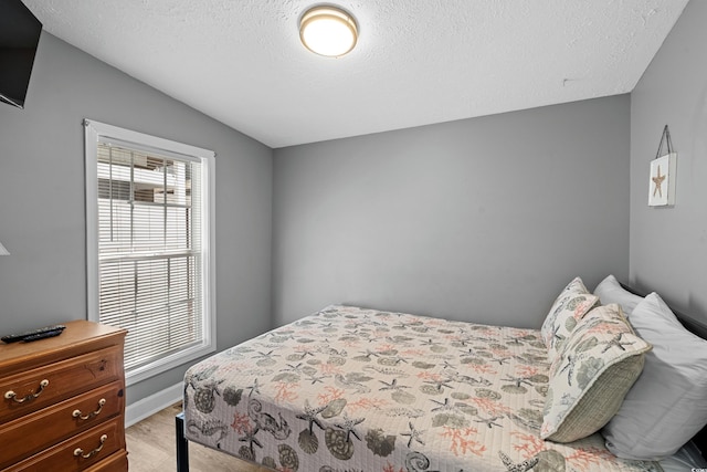 6001-1732 S Kings Hwy, Myrtle Beach, SC 29575 - bedroom with light wood finished floors, a textured ceiling, and vaulted ceiling