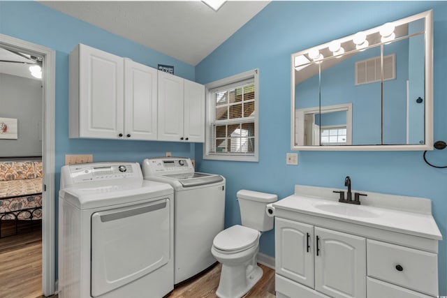 6001-1732 S Kings Hwy, Myrtle Beach, SC 29575 - bathroom featuring independent washer and dryer, lofted ceiling, toilet, vanity, and wood finished floors