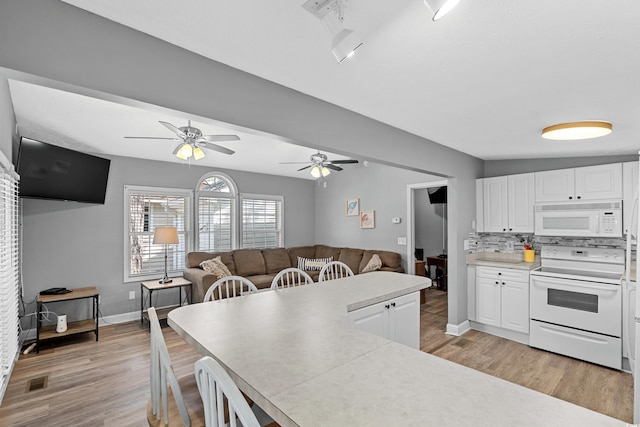 6001-1732 S Kings Hwy, Myrtle Beach, SC 29575 - kitchen with white appliances, light wood-style floors, white cabinetry, and ceiling fan