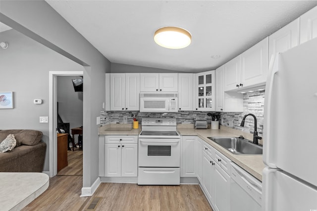 6001-1732 S Kings Hwy, Myrtle Beach, SC 29575 - kitchen featuring white appliances, a sink, decorative backsplash, light wood finished floors, and vaulted ceiling