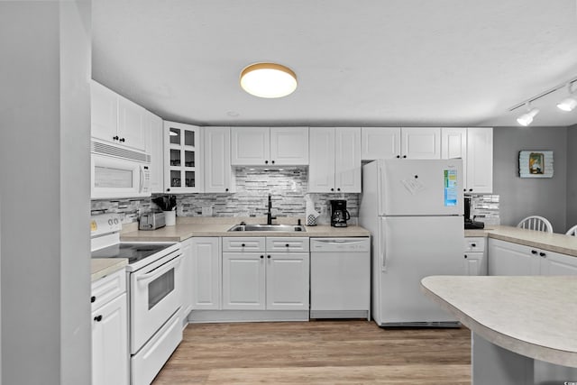 6001-1732 S Kings Hwy, Myrtle Beach, SC 29575 - kitchen featuring white appliances, a sink, decorative backsplash, and white cabinetry