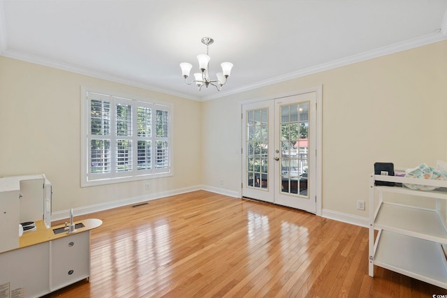 62 Warbler St, Georgetown, SC 29440 - unfurnished dining area with french doors, crown molding, wood finished floors, and a chandelier