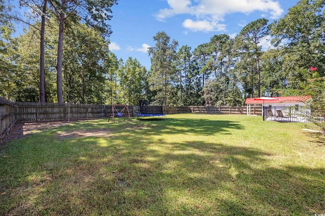 62 Warbler St, Georgetown, SC 29440 - fenced backyard with a trampoline
